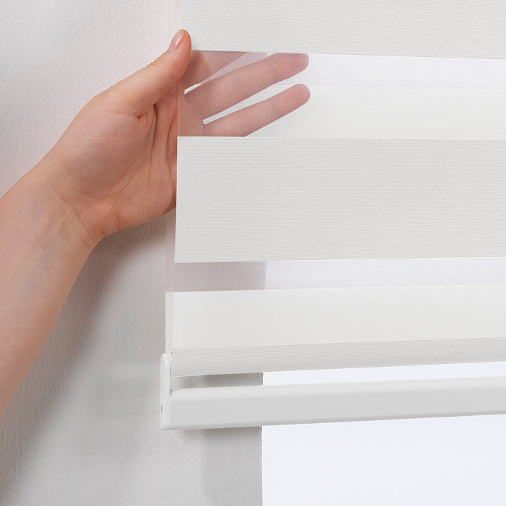 Made to measure solid plain white zebra roller blind featuring clean alternating sheer and dim‑out stripes for bright, adjustable light control and privacy, showcasing its crisp white tone, smooth texture and modern day‑and‑night blind design.