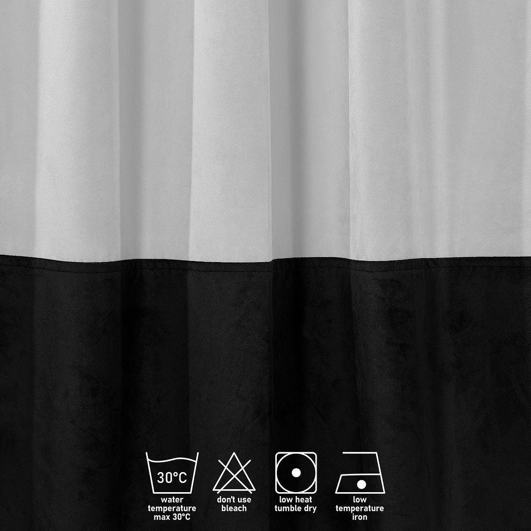 A close‑up of a white and black matte velvet block curtain, highlighting the soft texture and crisp two‑tone division