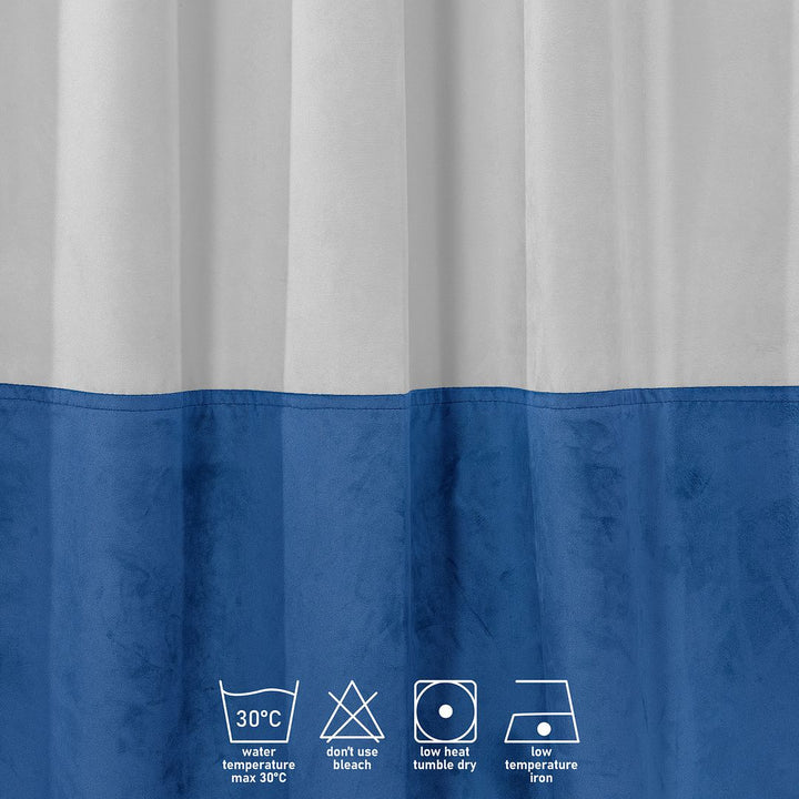 A close‑up of a white and blue matte velvet block curtain, displaying the soft texture and refined colour contrast