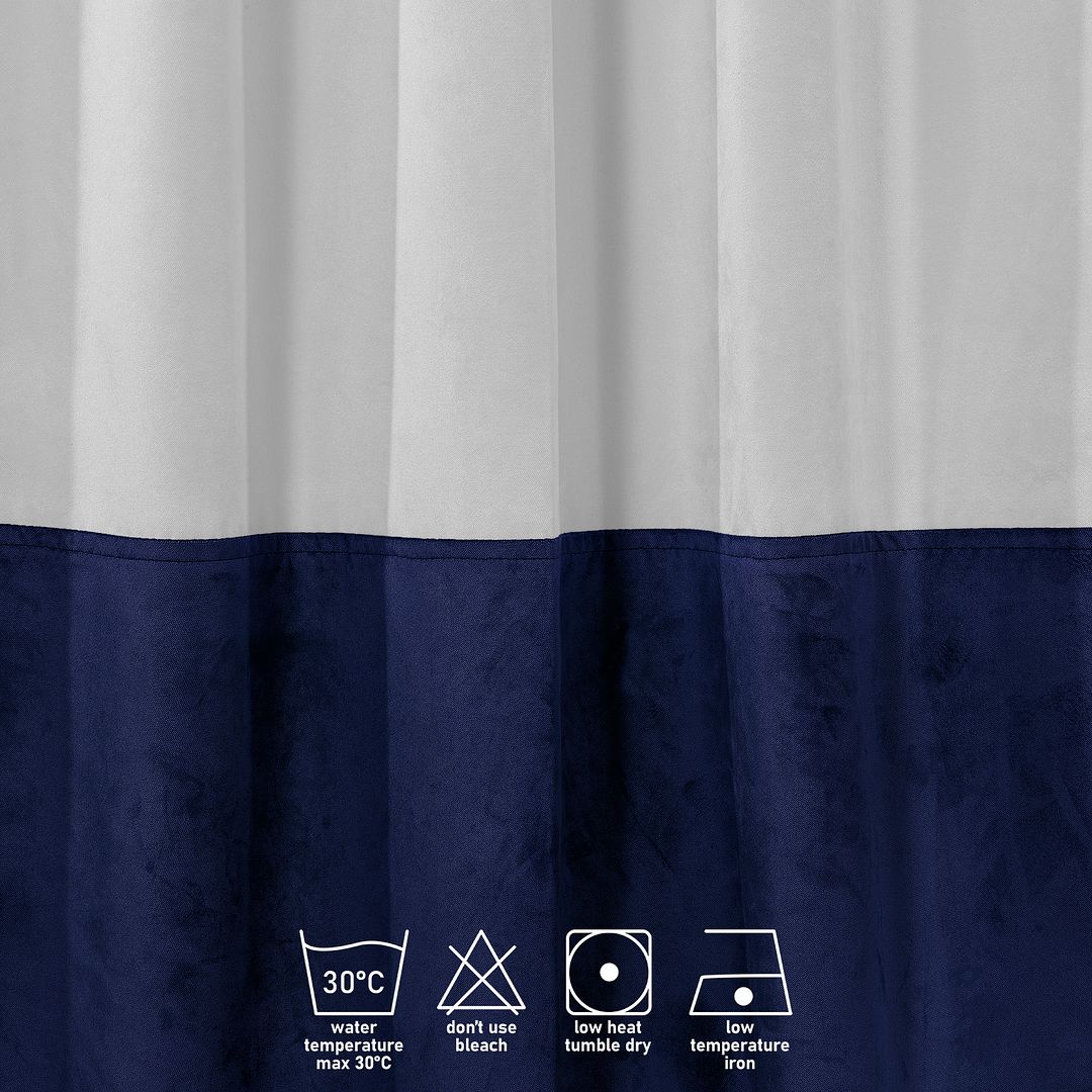 A close‑up of a white and midnight velvet block curtain, highlighting the plush velvet texture and crisp colour division