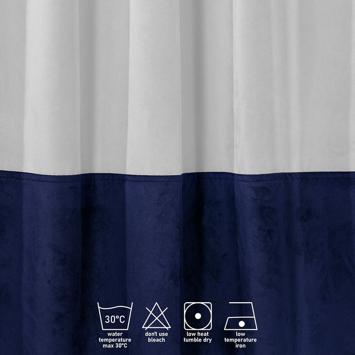 A close‑up of a white and midnight velvet block curtain, highlighting the plush velvet texture and crisp colour division