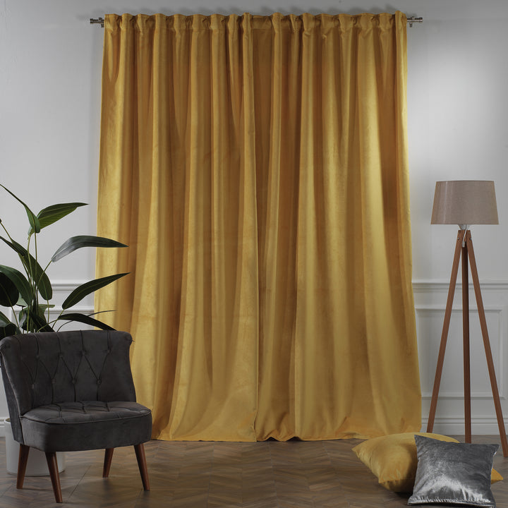 Yellow matte velvet eyelet curtain with metal ring top and warm, airy drape.