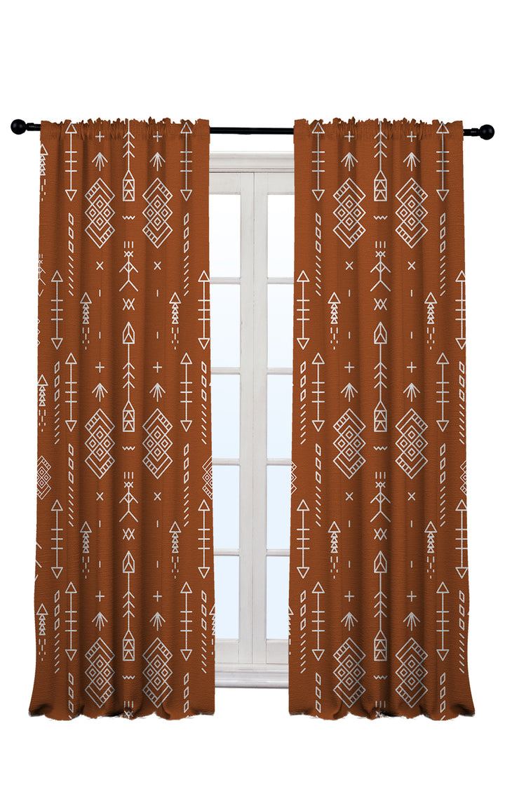 brick boho curtains with geometric pattern hanging on a rod against a white window background.