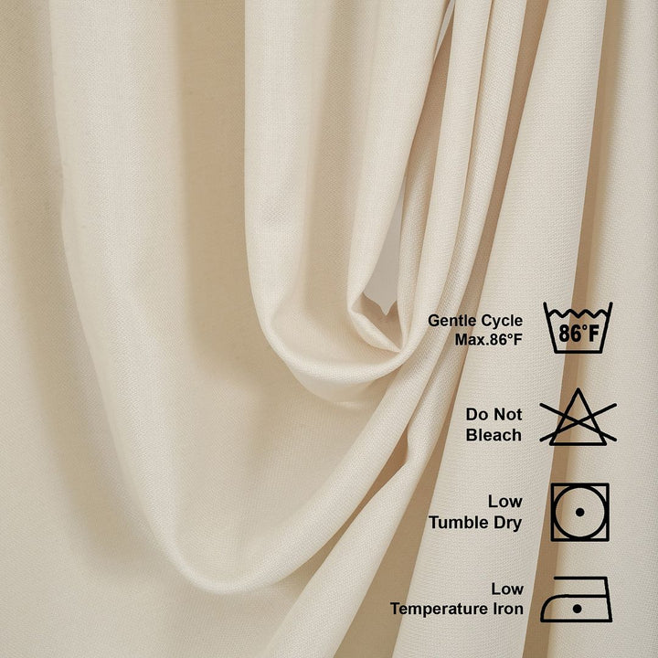 Beige fabric with laundry care labels on a beige background